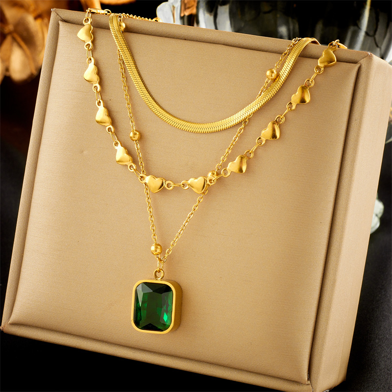 This is a high-end and versatile necklace with a multi-layer mixed and matched European and American fashion style, featuring a heart-shaped snake bone chain and an emerald diamond square pendant full figure