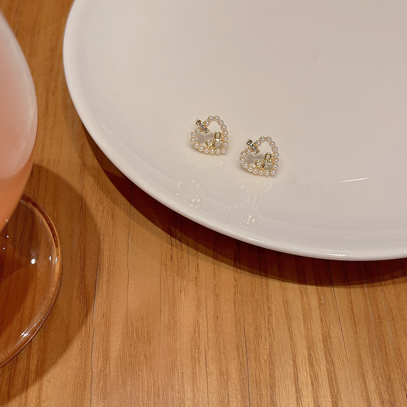 S925 Silver needle Korean new pearl heart-shaped earrings, women's light luxury style, versatile bow stud earrings wholesale Application Scenario