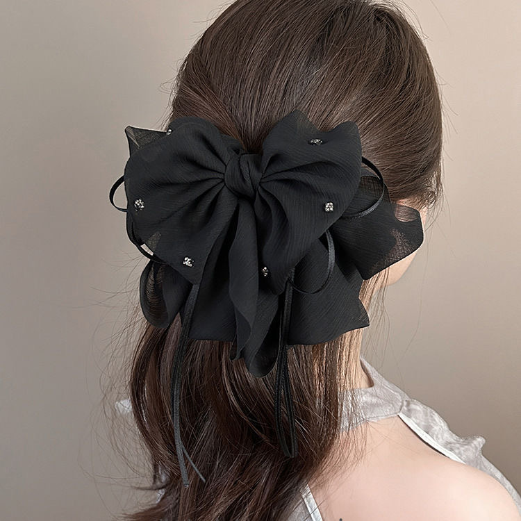 The elegant bow hair clip accentuates a woman's tall head. The ponytail hair clip exudes a sense of sophistication and grace. The half-tied hair is placed at the back of the head with a hair clip full figure