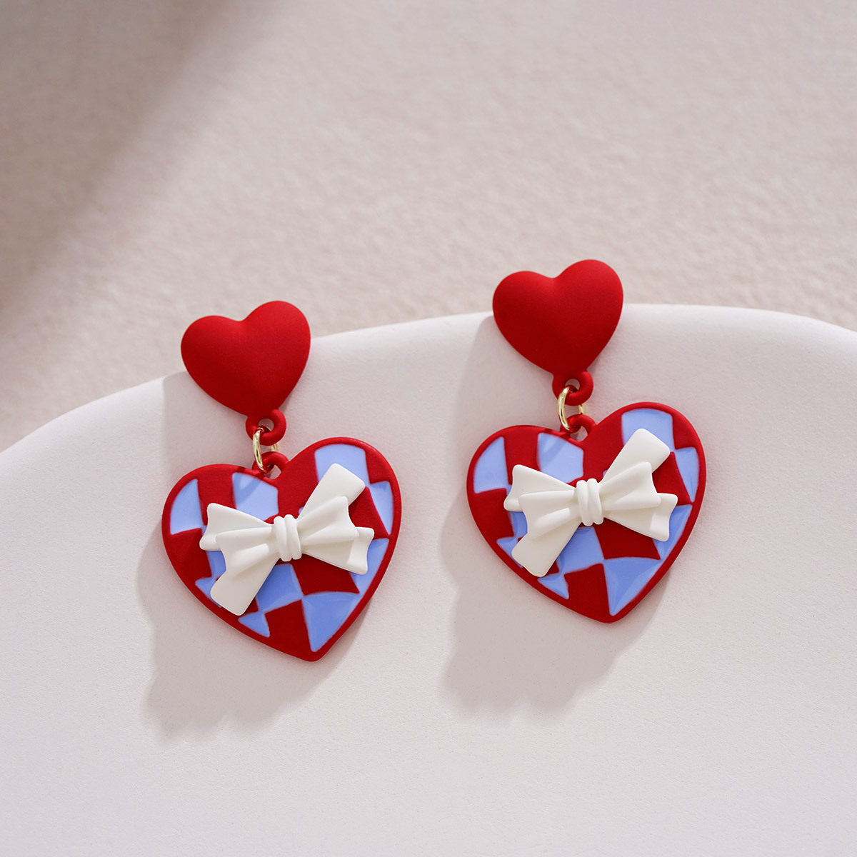 Red heart-shaped diamond pattern earrings, a unique and gentle touch. White bow stud earrings with a distinctive design. Valentine's Day women's earrings full figure