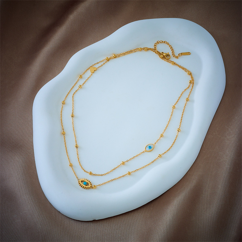 A double-layer mixed chain necklace with gold beads, titanium steel, oil-dripping and hollowed-out blue eyes, featuring a niche and fashionable design from Europe and America Specification drawing