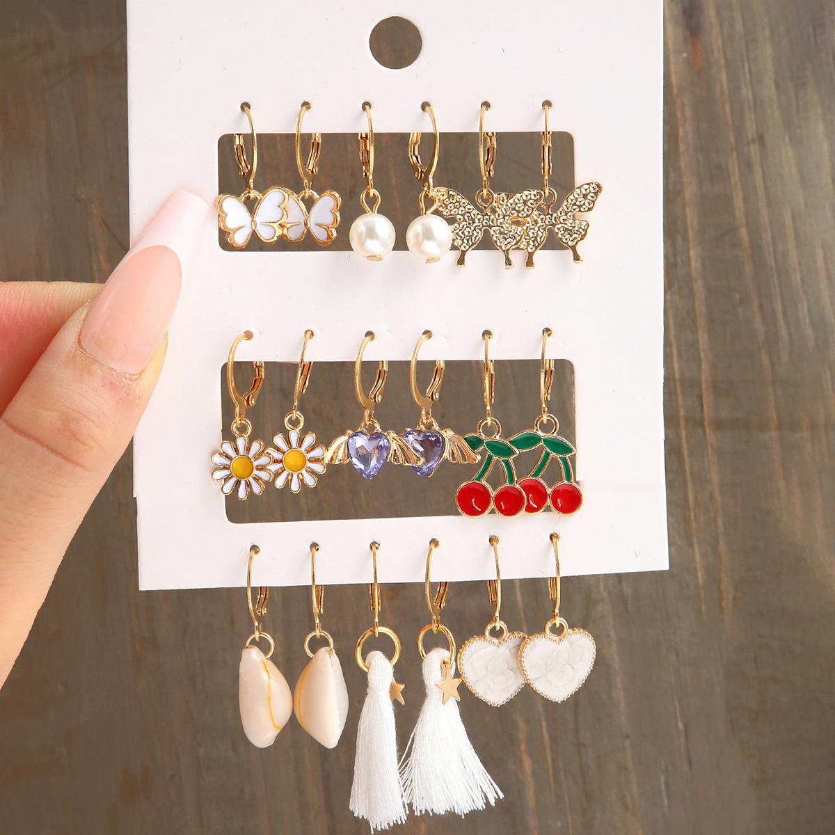 Wholesale of 9 pairs of creative butterfly heart cherry imitation pearl ear buckles in the new cross-border alloy rhinestone earring set full figure