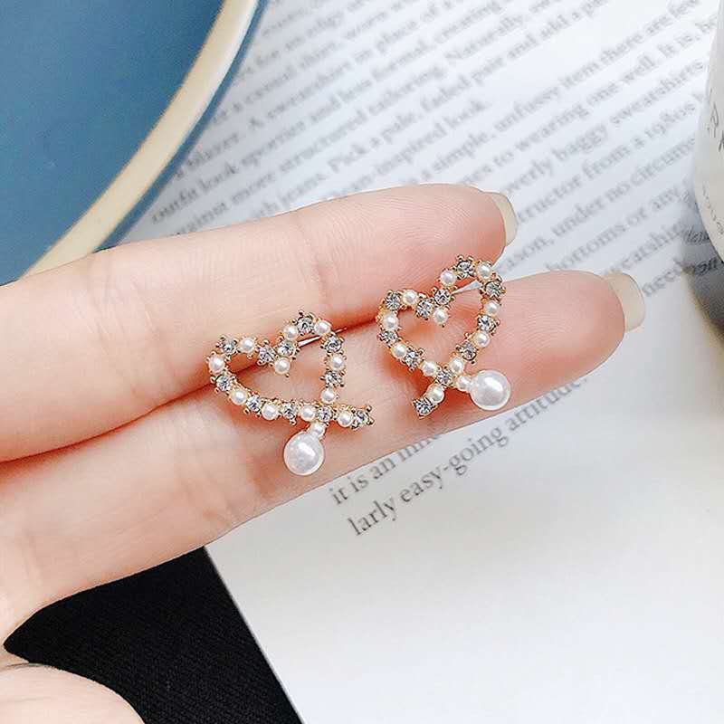 S925 Silver Needle Korean style, unique and irregular hollow heart-shaped pearl earrings, small and versatile, heart-shaped stud earrings for women details Picture