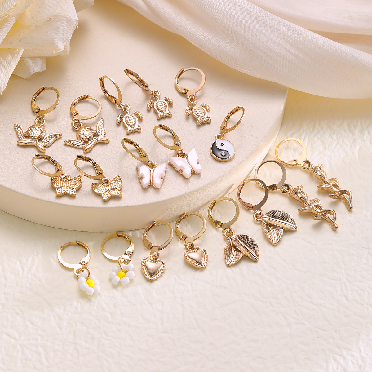 A new cross-border alloy-inlaid rhinestone earring set from Europe and America, featuring 9 pairs of creative butterfly, turtle, Tai Chi and flower earrings Application Scenario