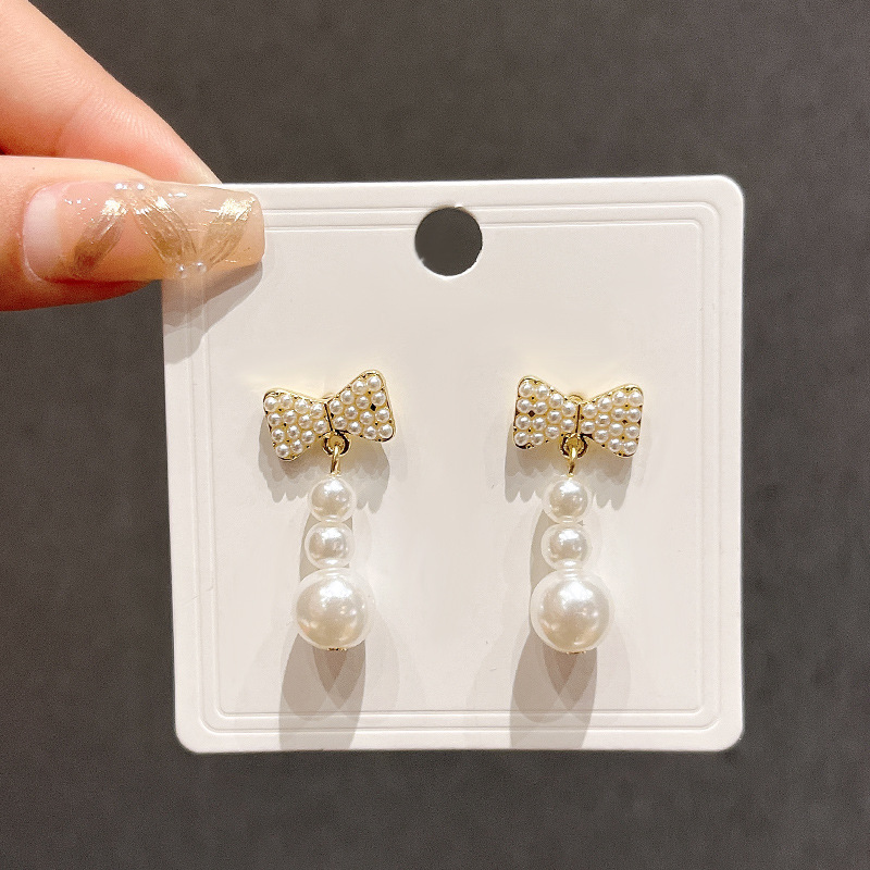 Chanel style bow slightly inlay pearl earrings, silver needle light luxury high-sensitivity earrings, versatile and elegant tassel earrings for women full figure