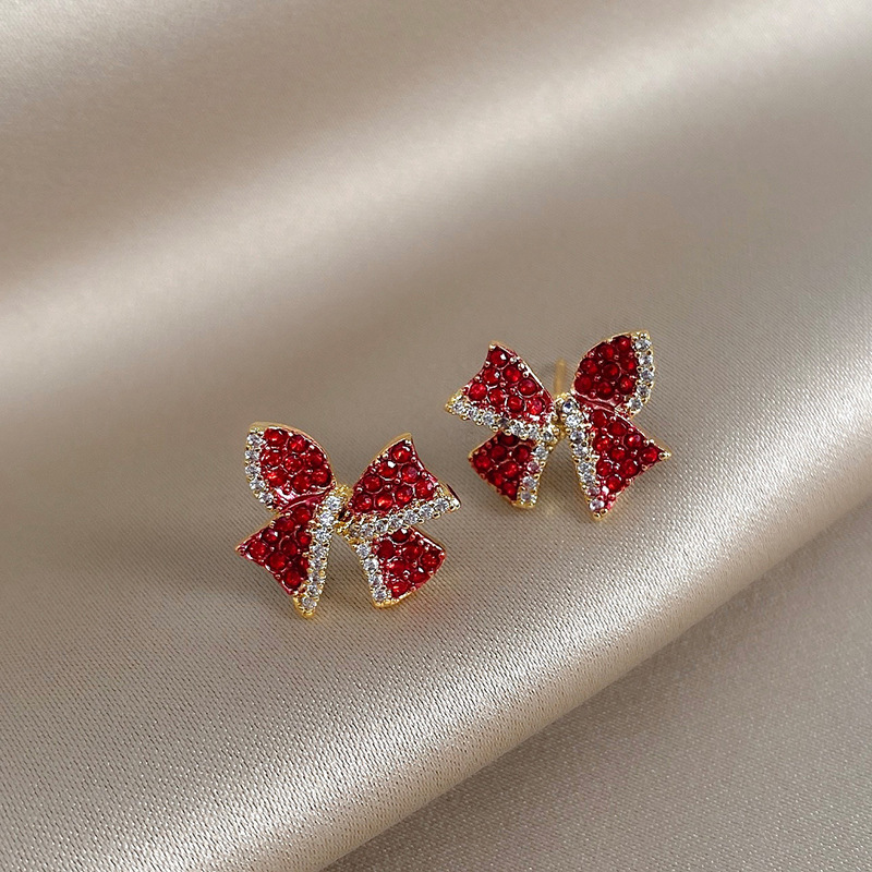 S925 Silver needle red diamond-encrusted personalized bow earrings, a simple and compact earpiece with a cold and aloof style for women, exuding a trendy vibe full figure