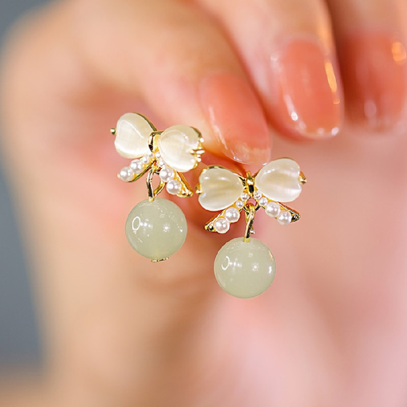 Cat's eye stone ear studs, pearl bow earrings, imitation Hetian jade earrings, niche design, light luxury and high-end sense of earrings for women full figure
