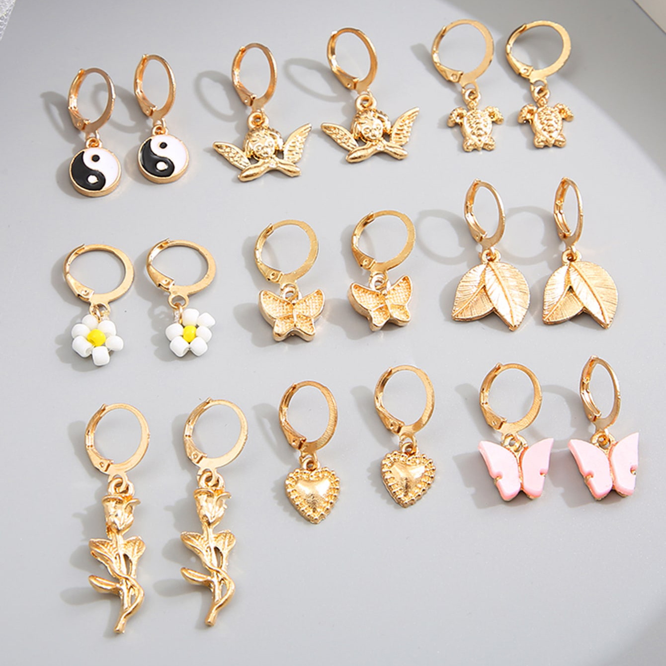 A new cross-border alloy-inlaid rhinestone earring set from Europe and America, featuring 9 pairs of creative butterfly, turtle, Tai Chi and flower earrings full figure