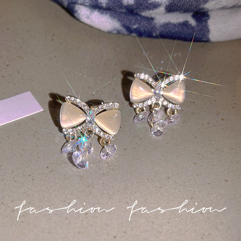 Cat's eye stone bow stud earrings, crystal tassel earrings, niche design sense, high-end earrings, light luxury and elegant earrings for women full figure