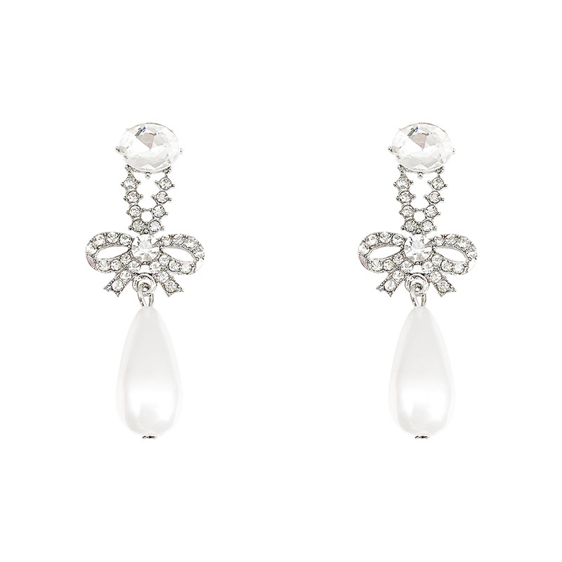 S925 Silver Needle Korean diamond-encrusted bow pearl Hundred-tower earrings, a fashionable, light luxury, individual and simple earpiece trend for women Item Picture