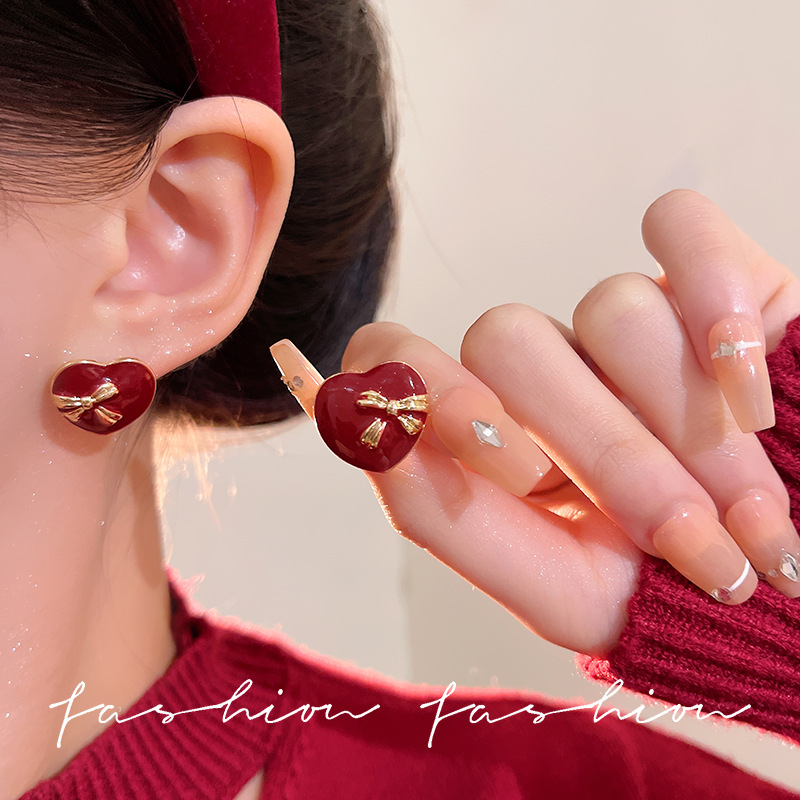 The Ankela red heart stud earrings feature a special design and a high-end feel. They are New Year's earrings with a retro Hong Kong style and a sweet Korean touch details Picture