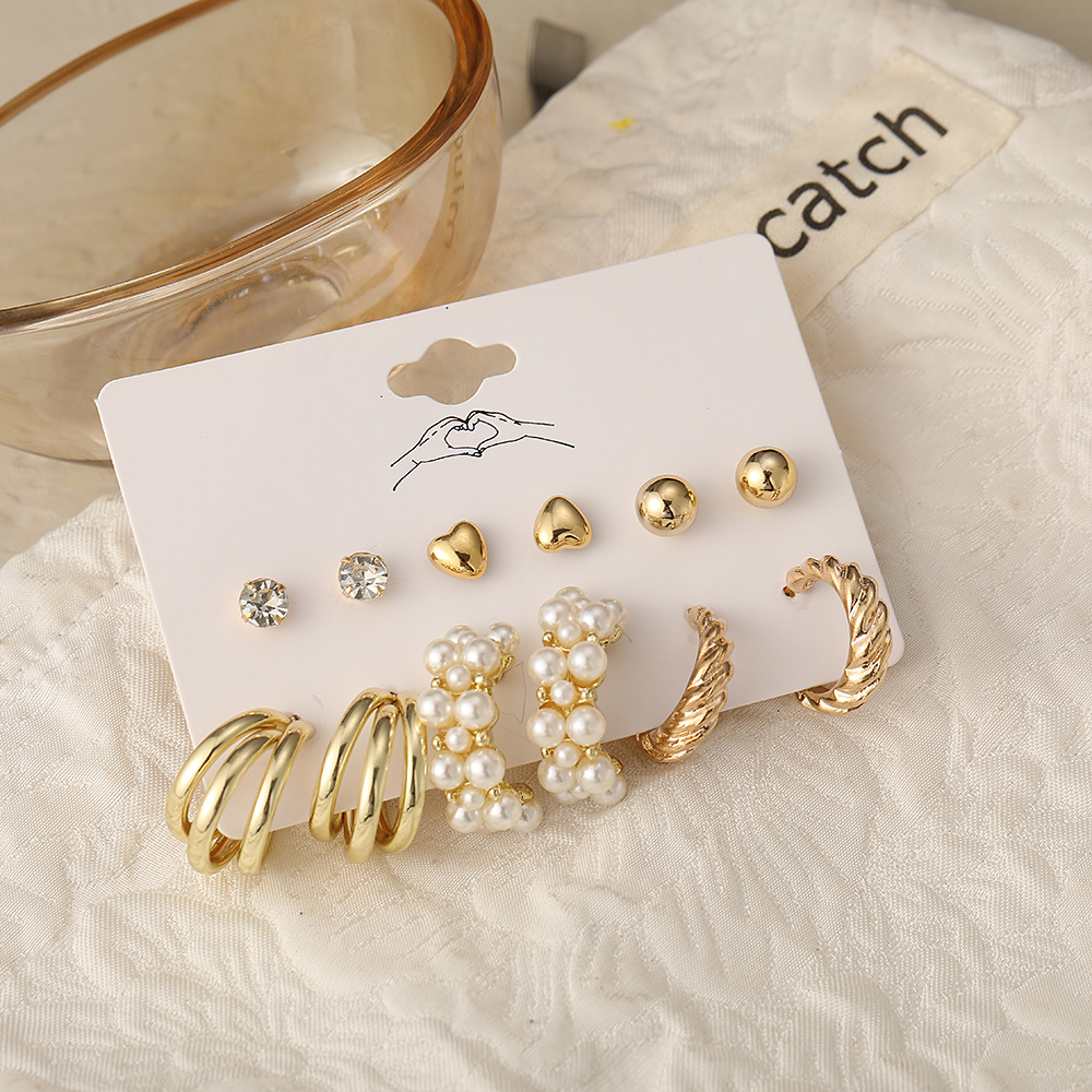 A cross-border bestseller set of 6-piece creative retro golden heart-shaped stud earrings with imitation pearl twist patterns, featuring an Instagram style for women Application Scenario
