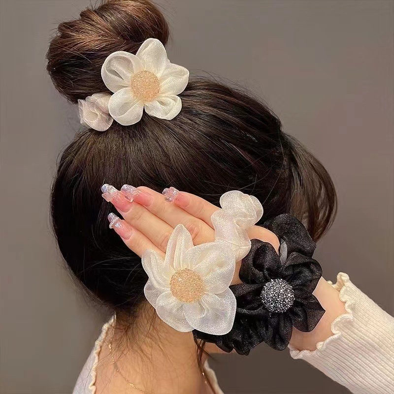 The new trendy hair accessory with a high-end Korean-style flower headband and a feminine charm. The organza large intestine band is used to tie the hair