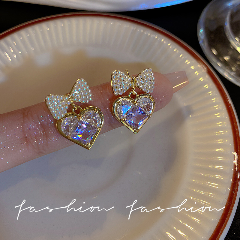 Silver needle pearl bow zircon heart-shaped earrings, cold style, niche design sense, simple and individual stud earrings for women full figure