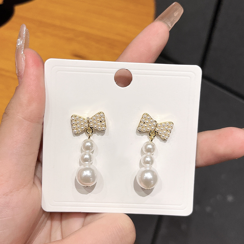 Chanel style bow slightly inlay pearl earrings, silver needle light luxury high-sensitivity earrings, versatile and elegant tassel earrings for women details Picture