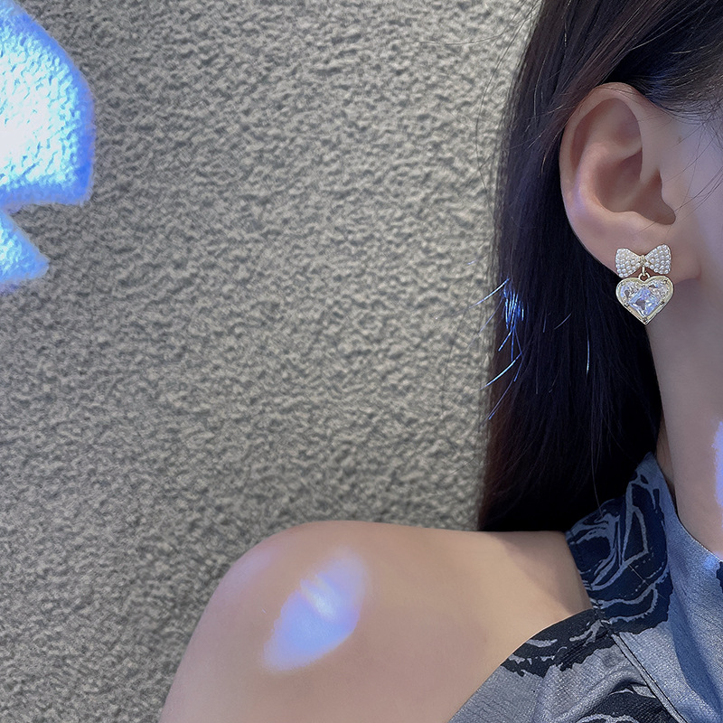 Silver needle pearl bow zircon heart-shaped earrings, cold style, niche design sense, simple and individual stud earrings for women details Picture