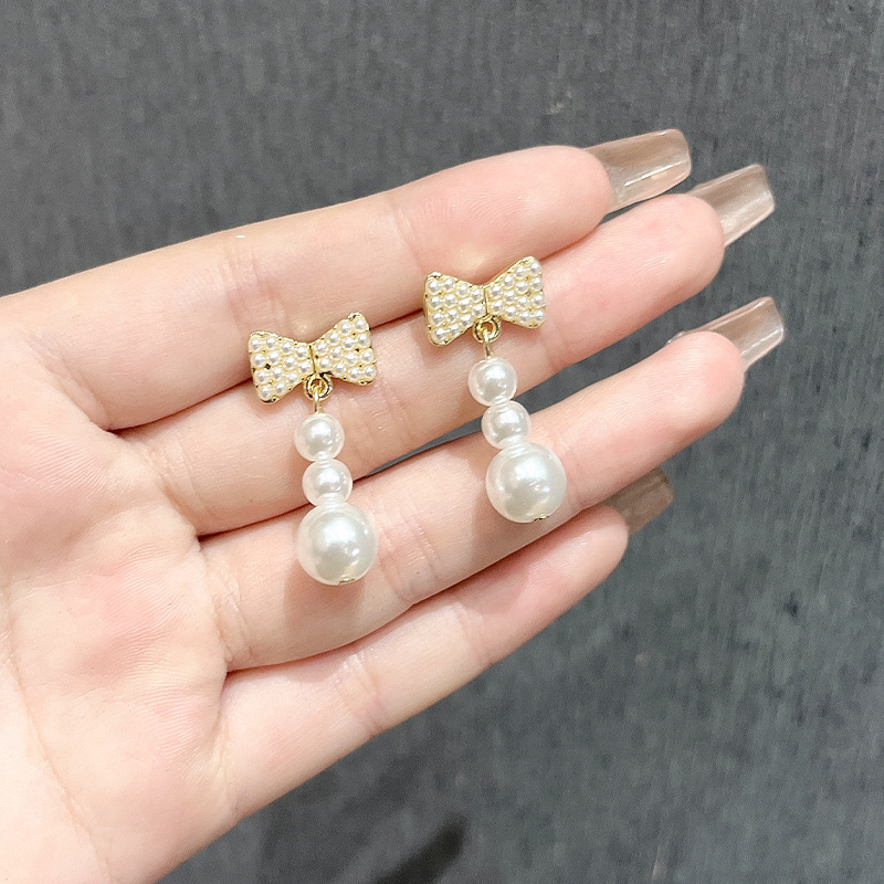 Chanel style bow slightly inlay pearl earrings, silver needle light luxury high-sensitivity earrings, versatile and elegant tassel earrings for women Application Scenario