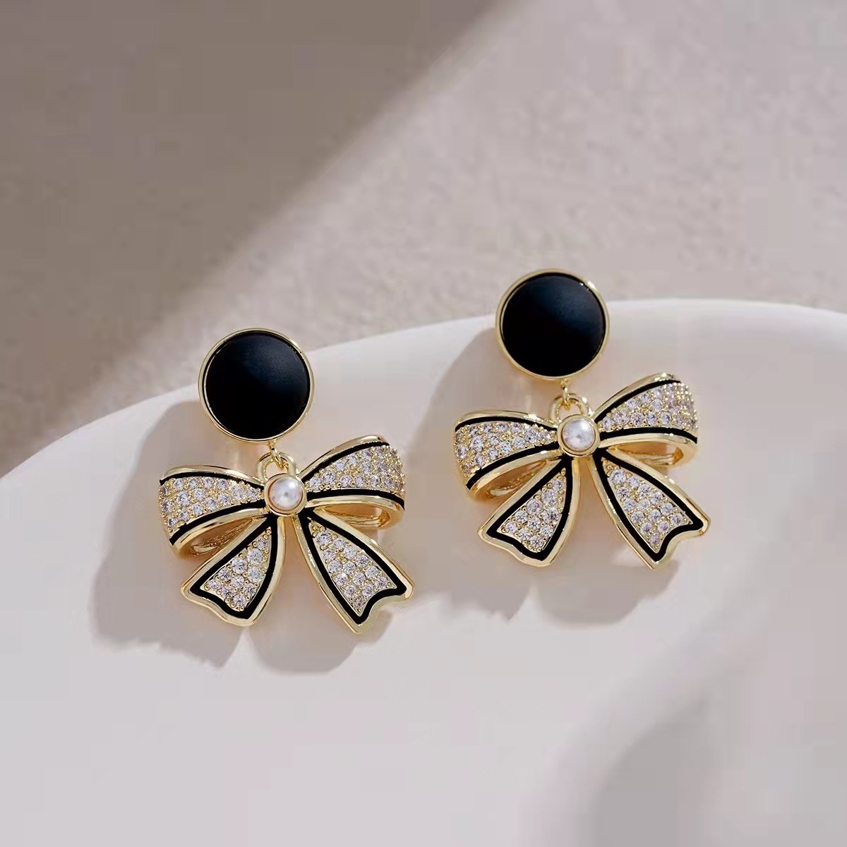 Korean black bow earrings with diamonds, exuding a light luxury vibe, and featuring a Hong Kong-style, niche design full figure