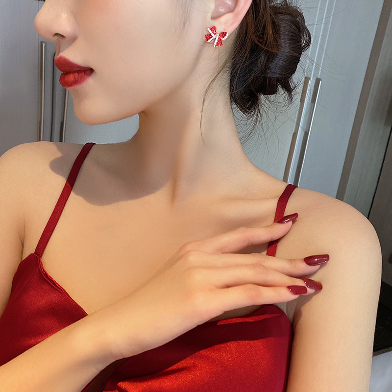 S925 Silver needle red diamond-encrusted personalized bow earrings, a simple and compact earpiece with a cold and aloof style for women, exuding a trendy vibe details Picture