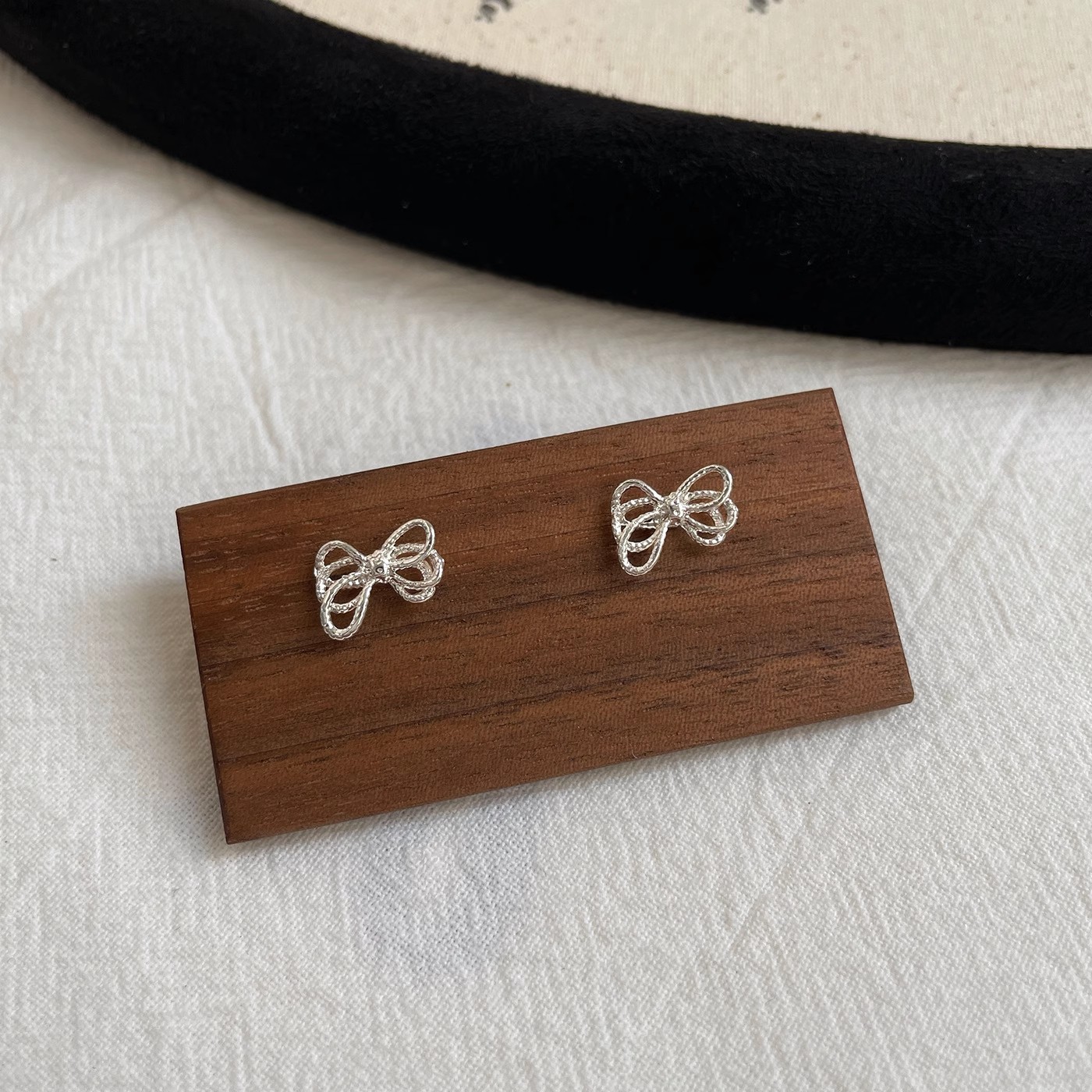 Korean-style twisted rope knot bow stud earrings, a niche design for women, versatile, simple and irregular hollowed-out earrings Application Scenario