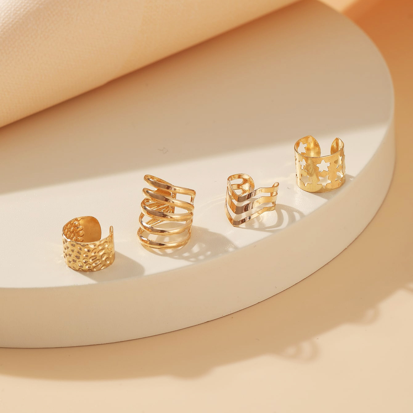 Creative and simple gold ear bone clip four-piece set, metal personalized star-shaped hollowed-out C-shaped ear clip set Application Scenario