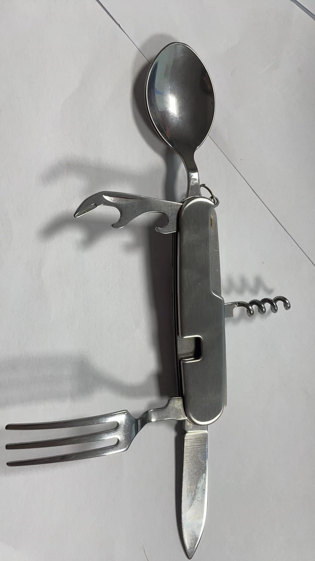 A variety of portable foldable and storable stainless steel knives, forks, spoons, outdoor multi-purpose camping tableware and creative picnic tools undefined