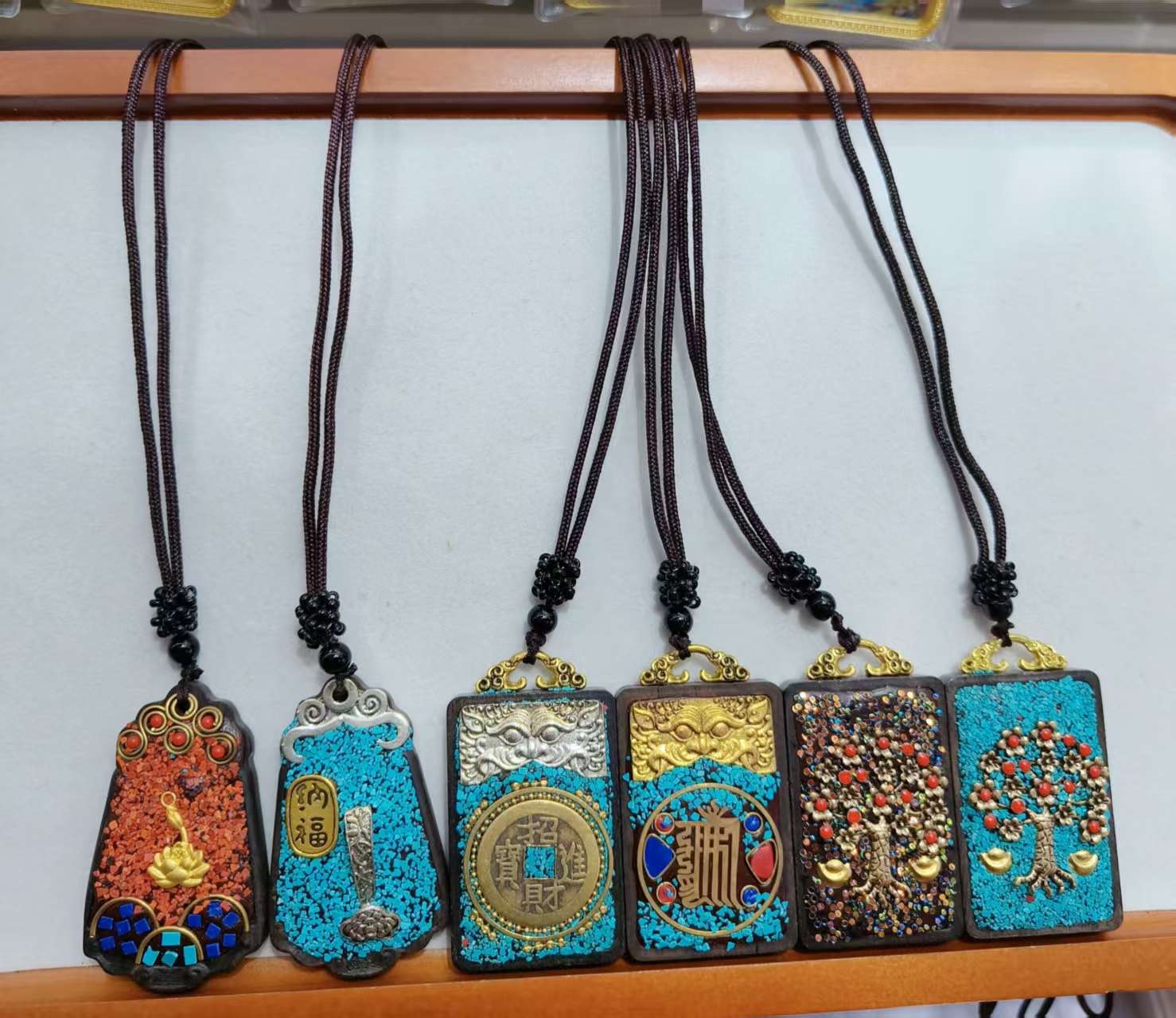 Handcrafted Indonesian Thangka necklaces made of sandalwood and clay, such as peace, good fortune, wealth, money tree, Zakiram, Yellow God of Wealth, Green Tara, etc Item Picture