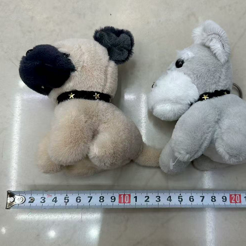 Stylish plush dolls in minimalist clothing displayed on a white shelf