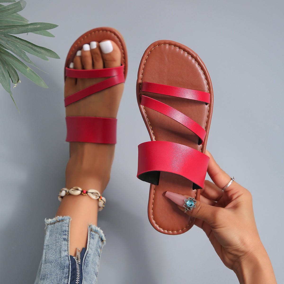 The 2025 summer new flat slippers are versatile for women's outdoor wear. They are Roman-style beach fashion slippers with anti-slip properties for women full figure