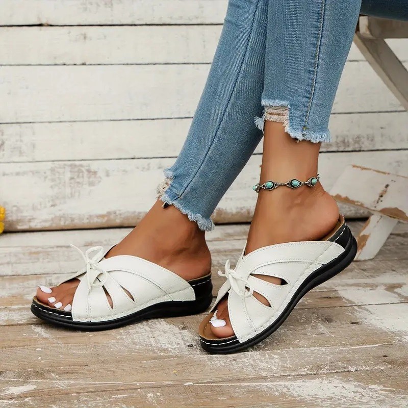 Cross-border trade large-sized bow wedge heel flat sandals 2025 new solid color fish-mouth hollowed-out hole shoes full figure