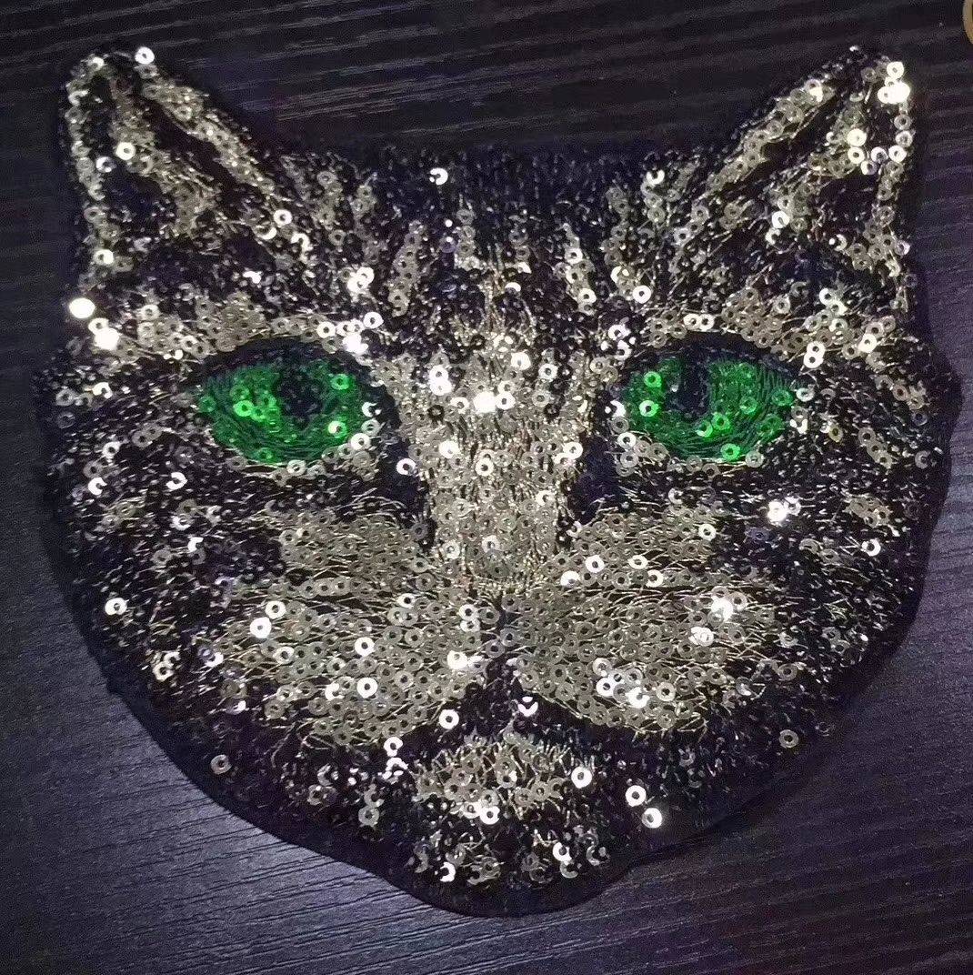 Beaded embroidered cat heads with green eyes are bestsellers Item Picture
