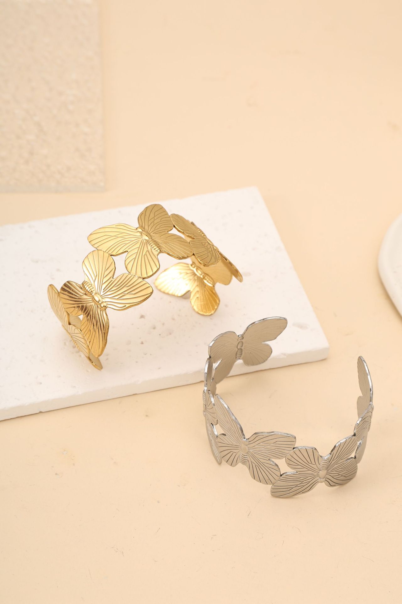 This titanium steel bracelet with a unique butterfly-shaped opening and adjustable design sense exudes a fashionable commuting and light luxury vibe, highlighting a white glove ring detail image 3