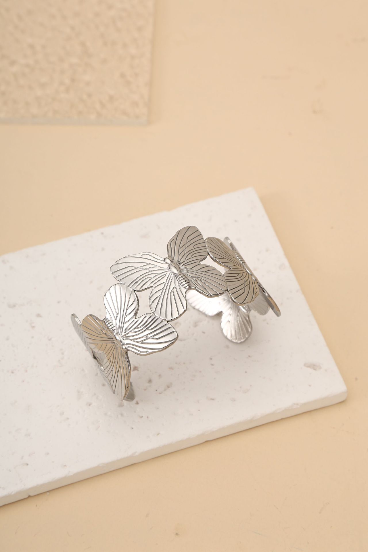 This titanium steel bracelet with a unique butterfly-shaped opening and adjustable design sense exudes a fashionable commuting and light luxury vibe, highlighting a white glove ring detail image 2