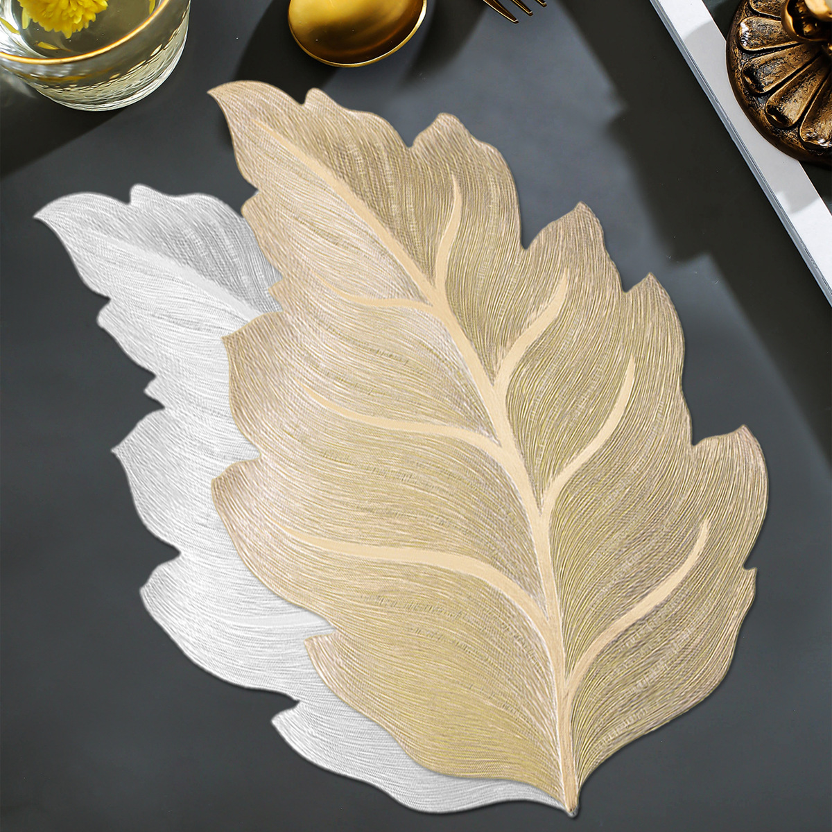 The gold-embossed leaf placemats are waterproof, oil-proof, easy to clean and washable
