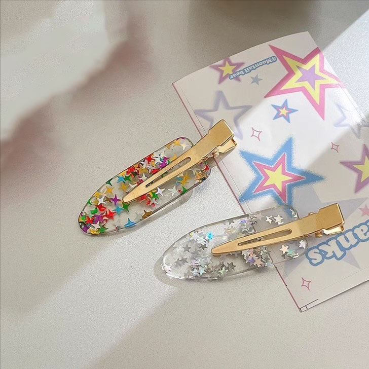 Acrylic traceless hairpin, a trendy and versatile product, factory direct sale and customization. Acrylic colorful five-pointed star, shiny and flowing sea hairpin wholesale