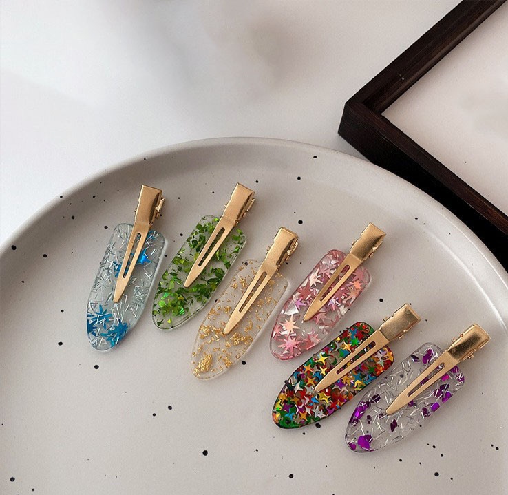 Acrylic traceless hairpin, a trendy and versatile product, factory direct sale and customization. Acrylic colorful five-pointed star, shiny and flowing sea hairpin wholesale detail image 2