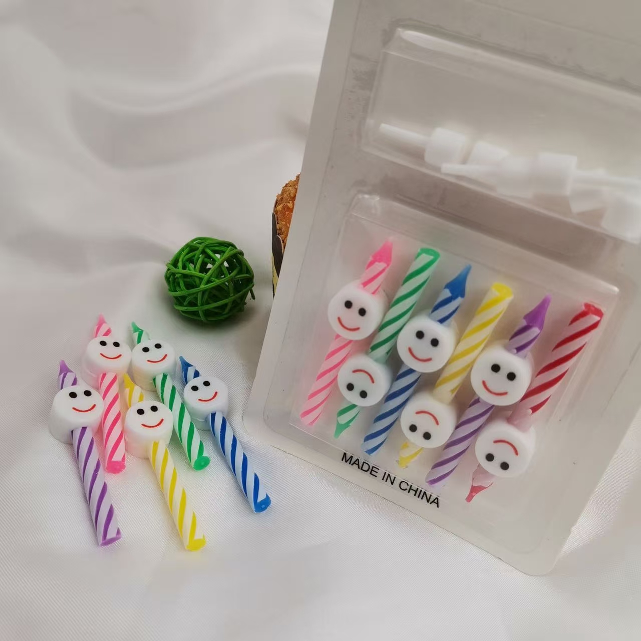 Five heart-shaped, smiling candles, colorful candles, party supplies, and birthday celebration items. detail image 3
