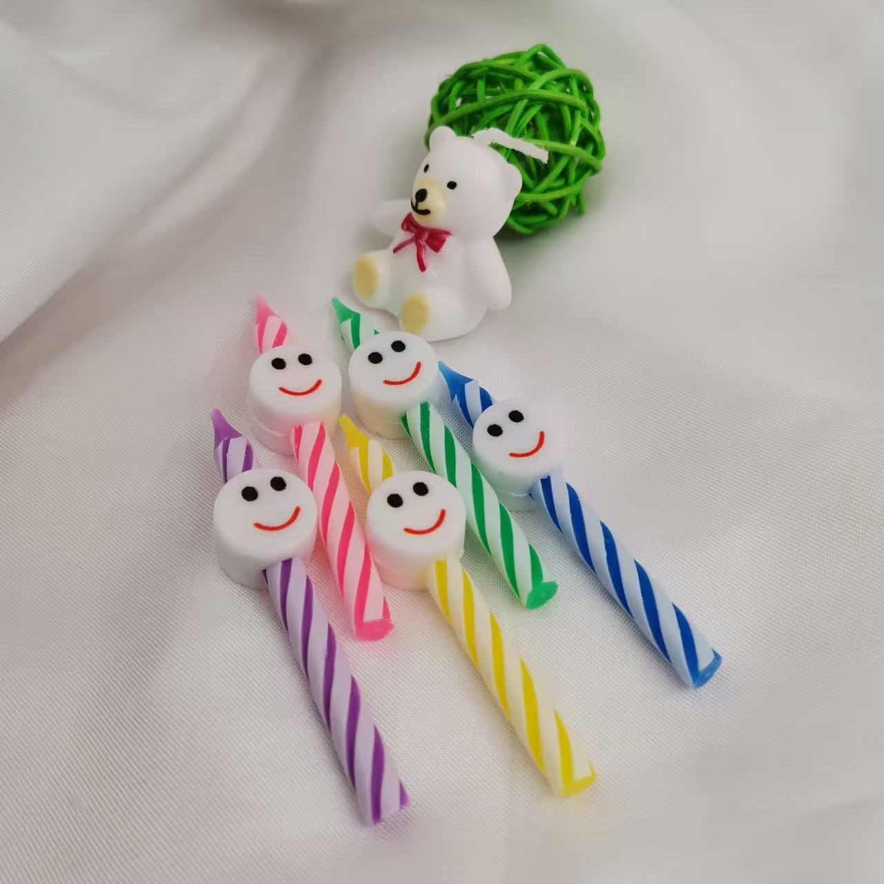 Five heart-shaped, smiling candles, colorful candles, party supplies, and birthday celebration items. detail image 4
