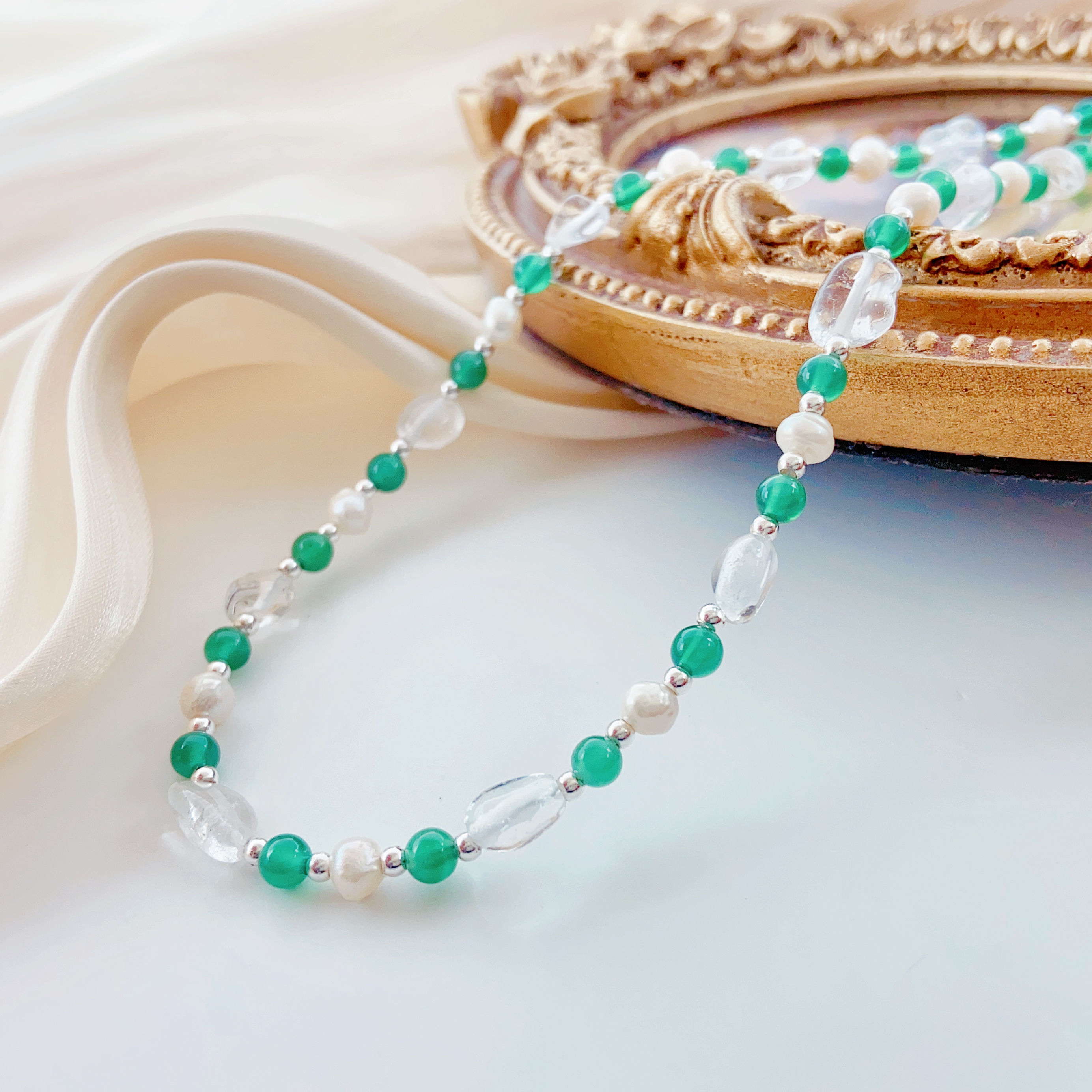 Layered pearl necklaces in various styles