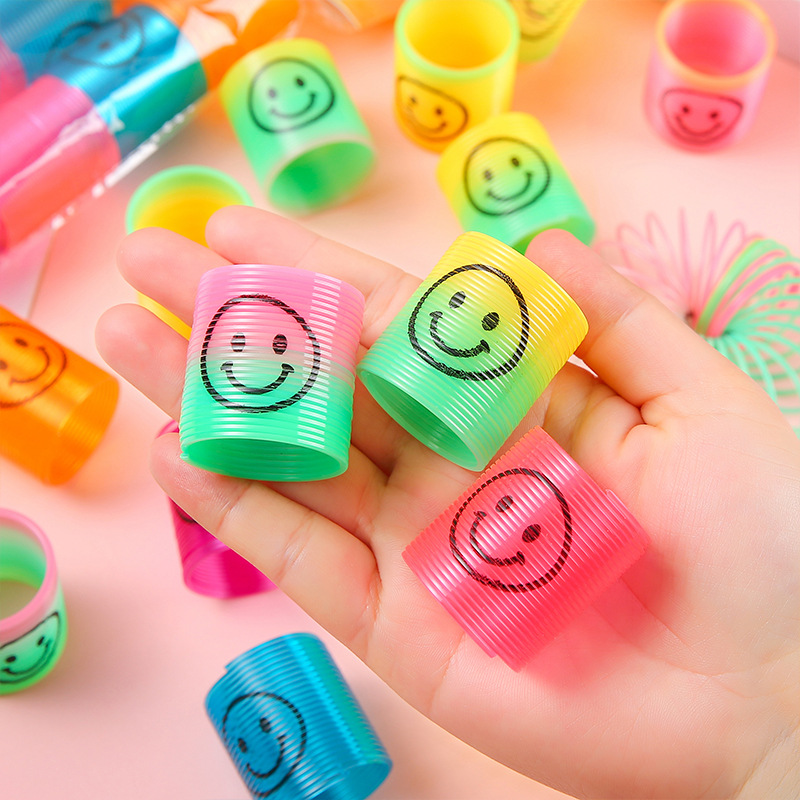 Children's colorful spring rings, mini smiling faces, rainbow rings, seven-color rings, elastic rings, street stall prizes, kindergarten gifts to play with full figure