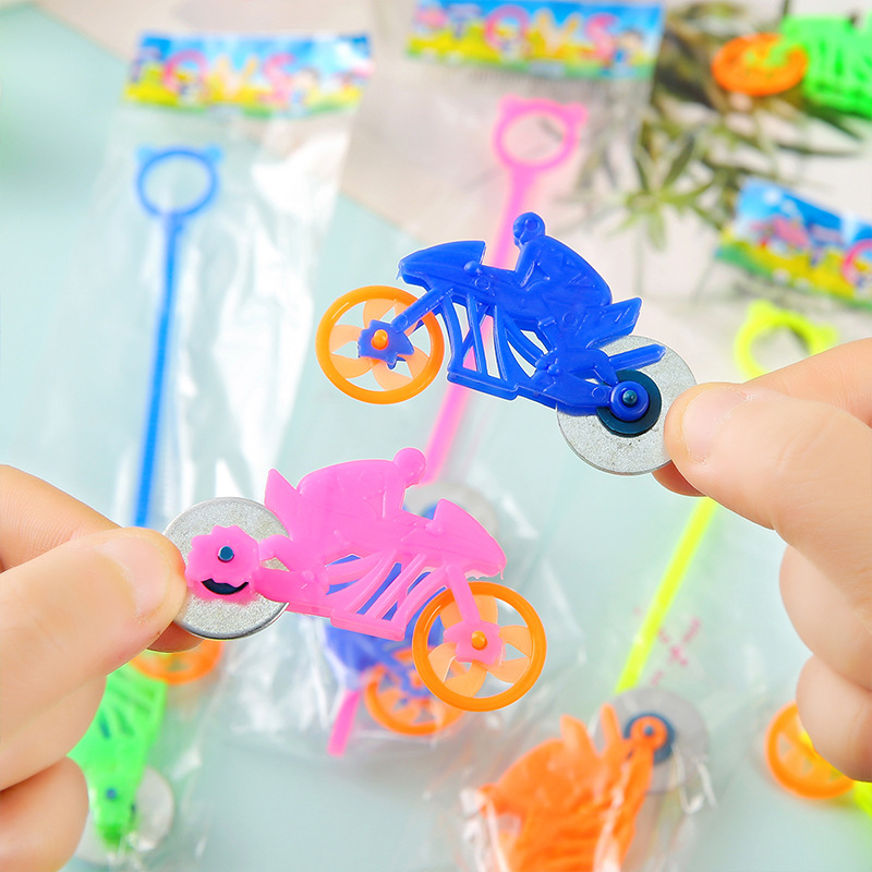 A nostalgic classic hand-pulled bicycle with a high-speed serrated wheel, a mini car, and a toy for children in their early years full figure