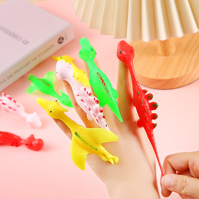 Wholesale of fun dinosaur catapulting toys, finger darts, little dinosaur stress-relieving soft rubber kindergarten gifts full figure