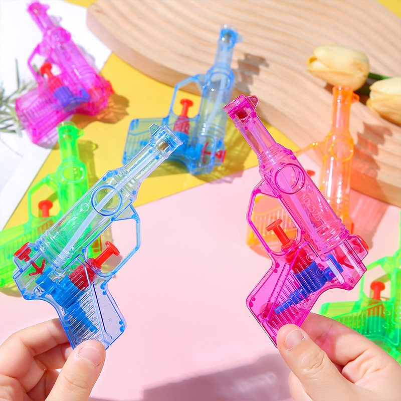 Mini candy-colored water guns, water play toys, beach water fights and children's gifts are selling well at street stalls in summer details Picture