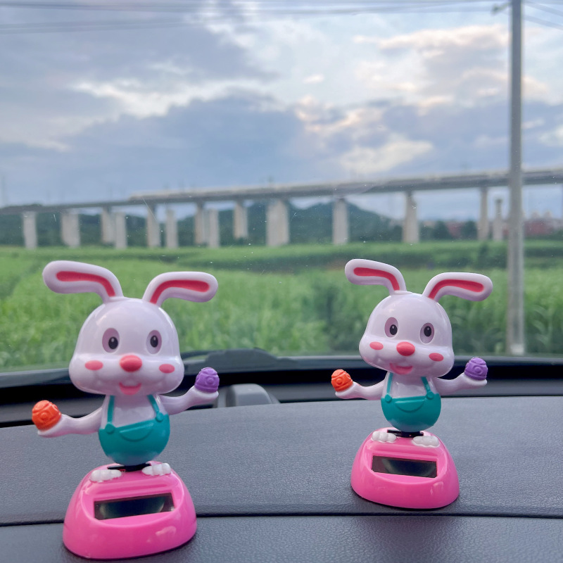 Solar-powered automatic swinging sunflower ear rabbit interior decoration, office furnishings, car ornaments, car accessories, cheap car decoration
