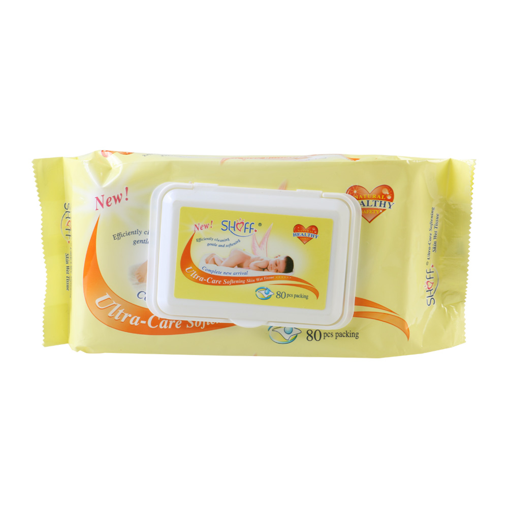 Baby smiling as parent gently cleans hands with Shoff wipe during outdoor playtime