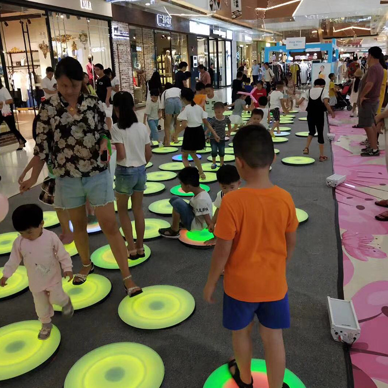 The new 500mm diameter LED circular floor tile light features a foot-sensing seven-color glow and a music color run full figure