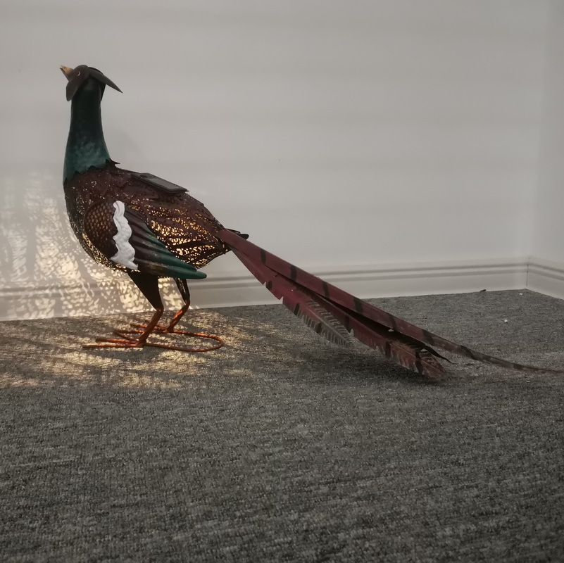 Outdoor solar lamps decorate the garden courtyard with animal statues and ironwork paintings of birds and pheasants for export from the UK and the US Specification drawing
