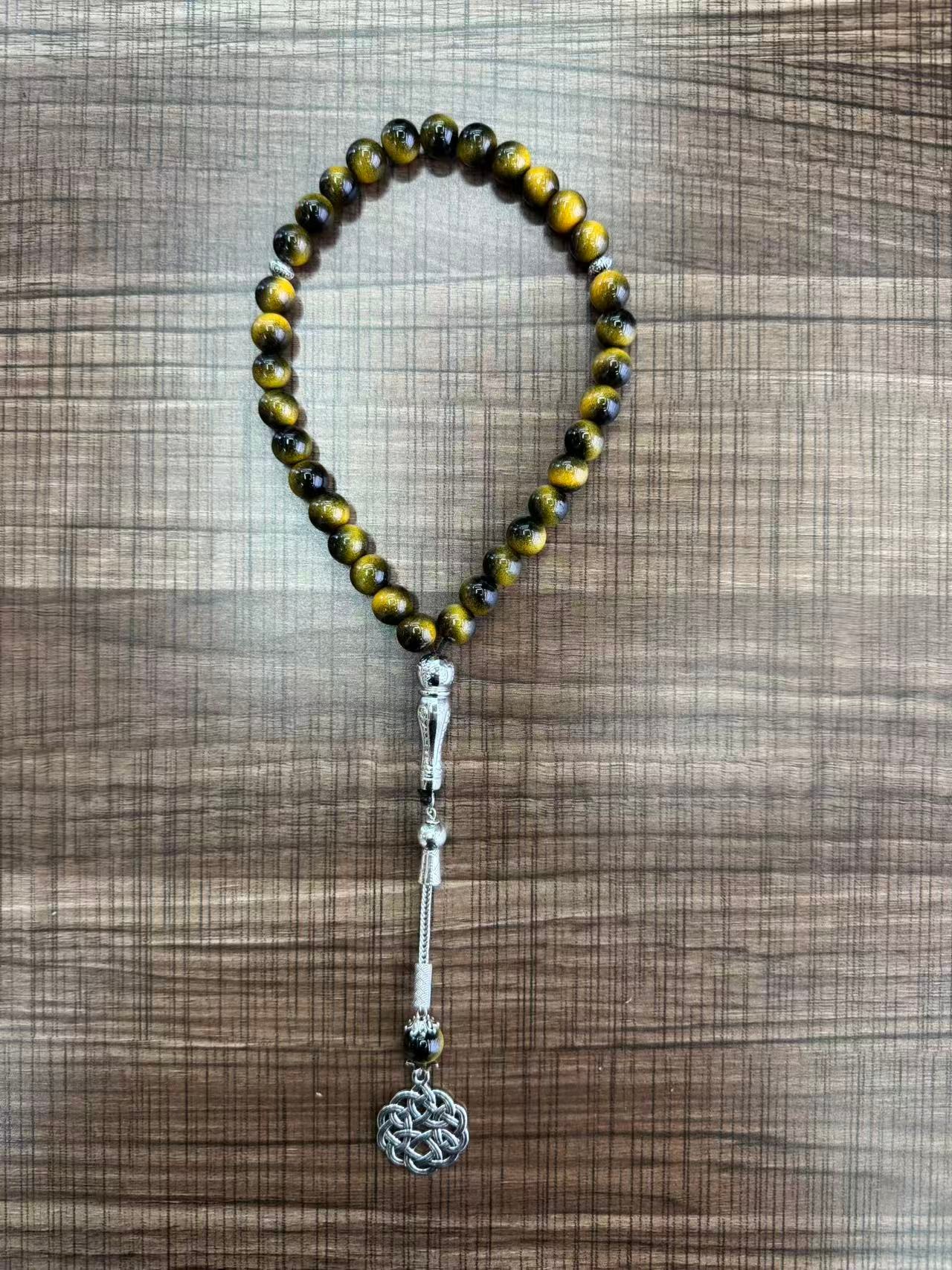 A new 33-piece hand-held prayer multi-color glass rosary that is selling well in the Middle East Specification drawing