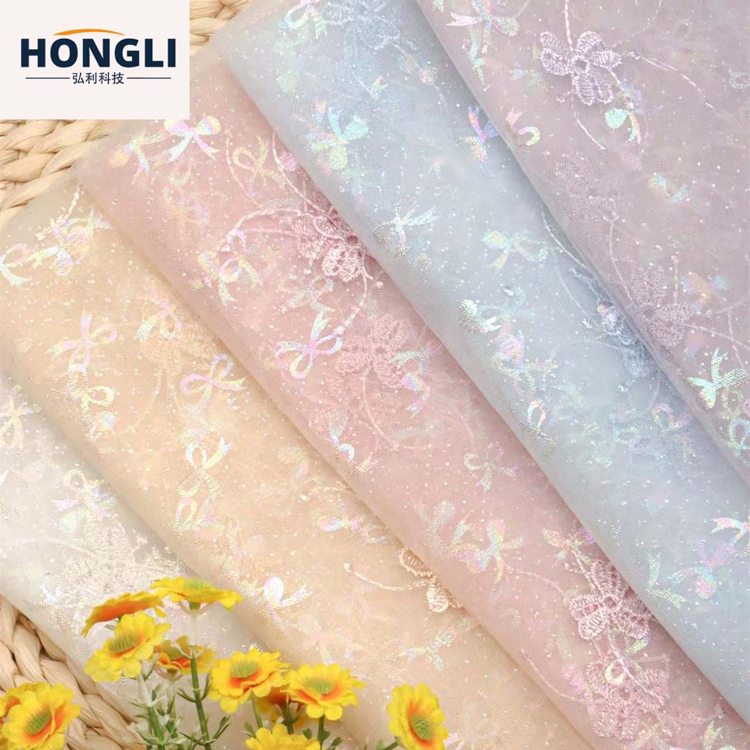 Hongli Technology HLJC-0181, a manufacturer, offers colorful clover embroidery, bow embroidery, mesh fabric, children's clothing embroidery, lace, wedding dress trim fabric. We support rice sample cutting, direct delivery and customization in stock