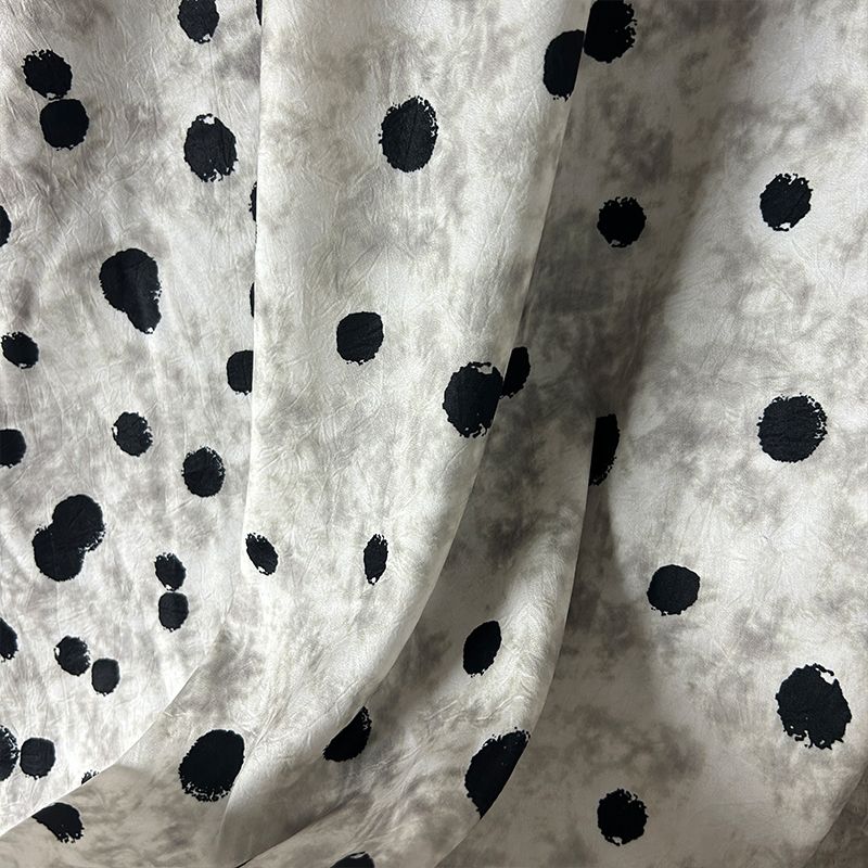 This fabric features a soft and drape design with a stir-fried grey base, slightly wrinkled satin finish, and irregular large polka dot printed acetate fabric Item Picture